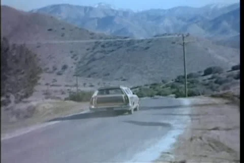 Rear view of station wagon driving fast on country road Stock Footage 25207850