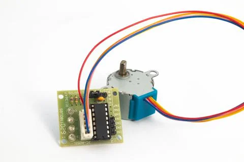 Rear view of a step motor module and its driver module connected by cables. T Stock Photos
