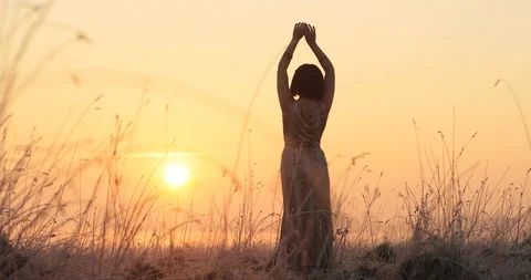 Rear view. sunset. on the floor stands a girl in a long dress with a snake print Stock Footage 126630494