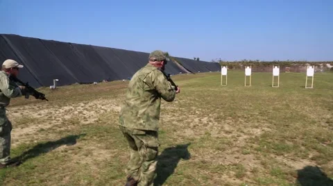 Rear View of Trainees Advancing and Firing on Target on Command Stock Footage 44188781