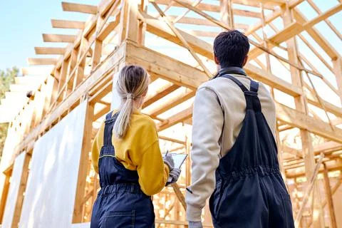 Rear View On Two Builders In Working Uniform Explore Construction Documentation Fotos de archivo