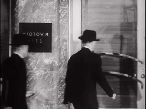 Rear view of two men walking into apartment building, 1930s Stock Footage 61766932