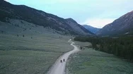 Rear View Of Two Motorcyclists Travelling Through Green Mountain Valley, Wyoming Stock Footage