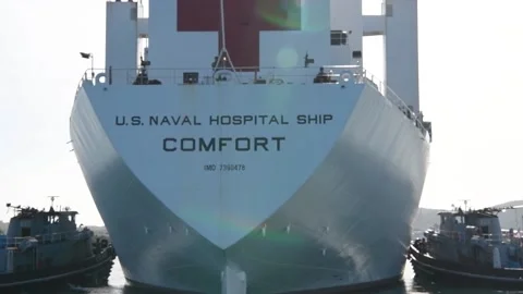Rear View of two pilot ships turning U.S. Navy hospital ship USNS Comfort Stock Footage 227138778