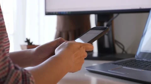Rear view of unrecognizable person using smartphone, typing. Stock Footage 173746885