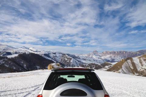 Rear view of the unrecognizable upper part of an SUV high in the mountains in Stock Photos