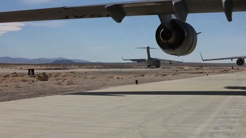 Rear view USAF C-17 Globemaster III landing on runway next to parked C-17 Stock Footage 263721472