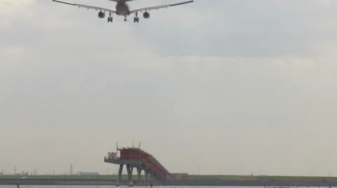 Rear view variation of a modern jet descending to touchdown. Stock Footage 61718960