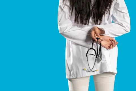 Rear view while young female doctor's hands holding a stethoscope. Foto stock