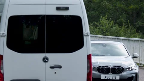 Rear view of white van driving on bridge, cars passing by in opposite direc.. Stock Footage 332688417