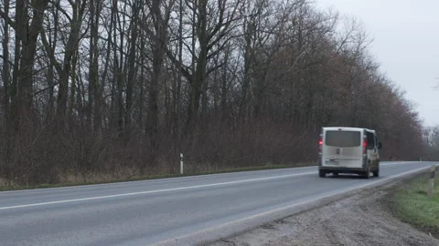 Rear view of white van passing on rural highway, engine and tire whoosh traffic Stock Footage 323909369