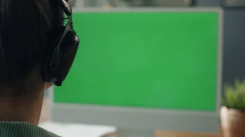 Rear view of woman working on computer with green screen Stockbeeldmateriaal 231759445