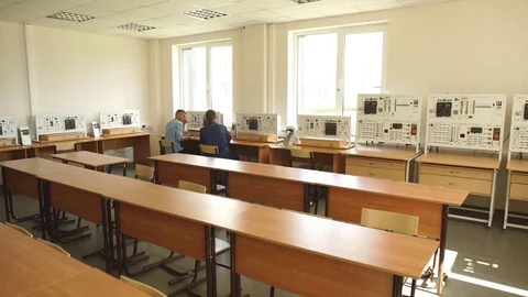 Rear view of workers in the control room, looking at computer monitor Stock Footage 70798585