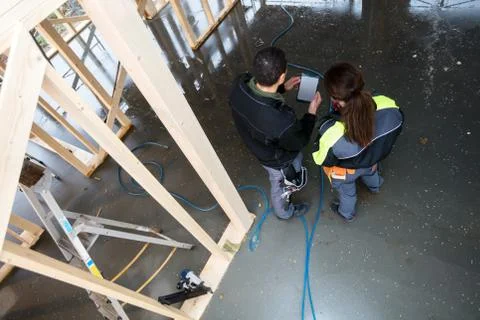 Rear View Of Workers With Digital Tablet At Site 写真素材