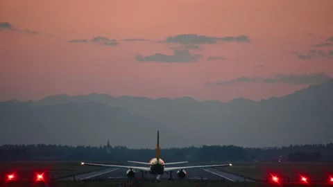 Rear view of yellow DHL cargo airplane taking off on the runway Stock Footage 202198792