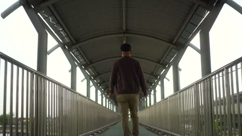 Rear view of young blind man walking step along the flyover with a white cane. Stock-Footage 276484988