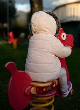Rear view of a young child in a playground Stock Photos