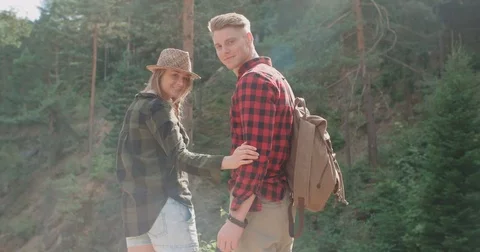 Rear view of young couple spending time in woods. Видео 81632202