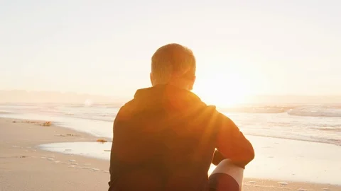 Rear View Of Young Man On Beach Watching Sun Rise Over Ocean Stock Footage 95597532