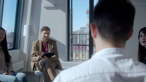 Rear view of young man being interviewed in large IT company Stock Footage 128441880