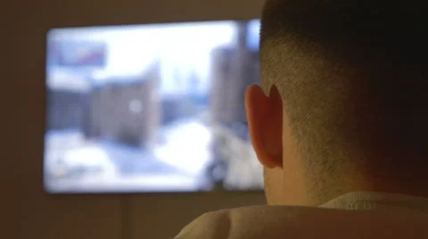 Rear view of a young man playing on a console Stock Footage 61750407