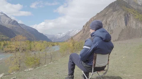 Rear view young man sitting on river bank relax enjoying nature contemplation 4k Stock Footage 85451446