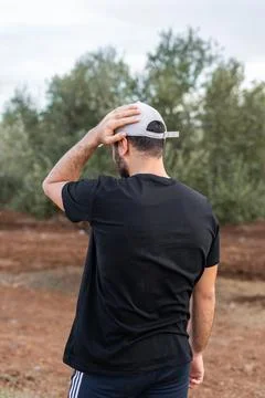Rear view of a young man wearing black unbranded t-shirt Stock-Fotos