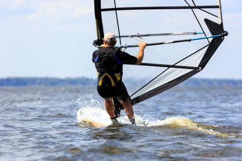 Rear view of young windsurfer Stock Photos