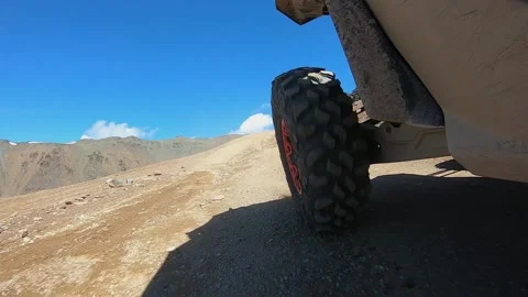 The rear wheel of the buggy rides on a mountain road Stock Footage 161242080