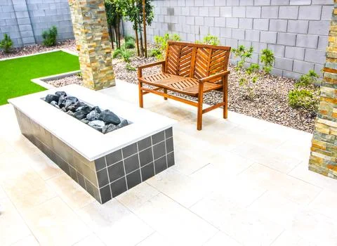 Rear Yard Raised Fire Pit With Wooden Bench Stock Photos