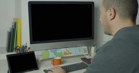 Rearview of a caucasian man during a session work on the desktop computer Stock Footage 148239967
