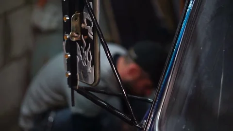 Rearview mirror and a man repairs car on the background Stock Footage 80320153