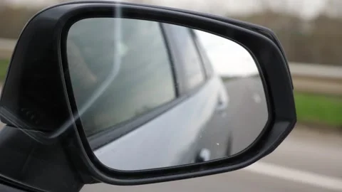 Rearview mirror captures dynamic motion of vehicles on the highway, traffic Stock Footage 319067373