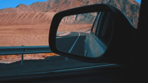 	Rearview mirror gray car. View from moving car during trip in desert road Stock Footage 103456012