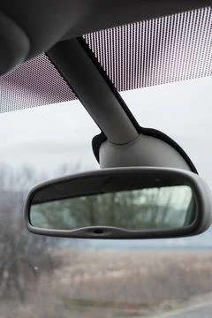 Rearview mirror reflection of nature set against a beautiful winter scenery. Stock Photos
