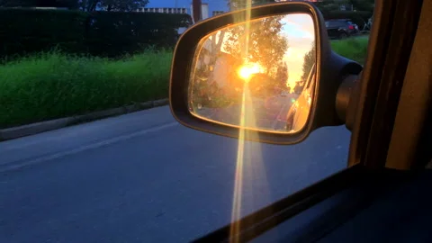 Rearview mirror at sunset from inside the car Stock Footage 143167005