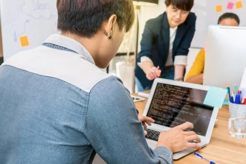 Reaw view of businessman using the computer over the couple Of Asian and Mult Stock Photos