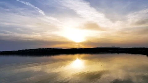 Rebound drone view capturing evening sun on calm and calm sea Stock Footage 241423380