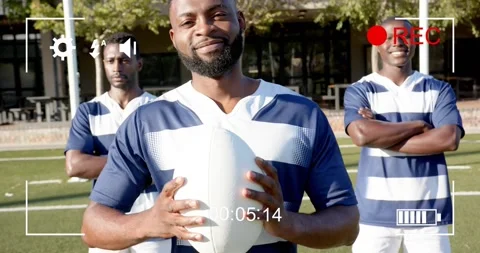 REC indicator flashing as camera pulling back, lead player holding rugby ball Stock Footage 330647274