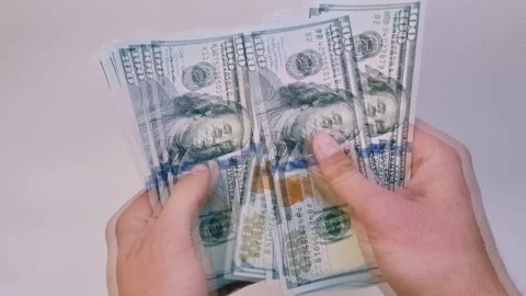 Recalculation of bundle of one hundred dollar bills Stock Footage 165844763