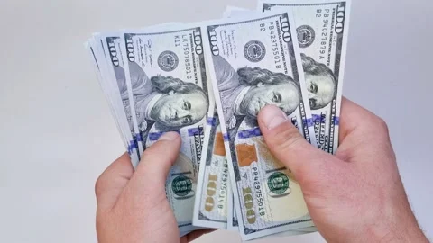 Recalculation of bundle of one hundred dollar bills Stock Footage 165844764