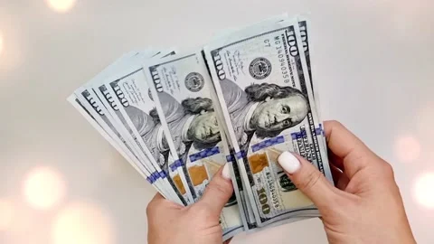 Recalculation of bundle of one hundred dollar bills Stock Footage 165847576