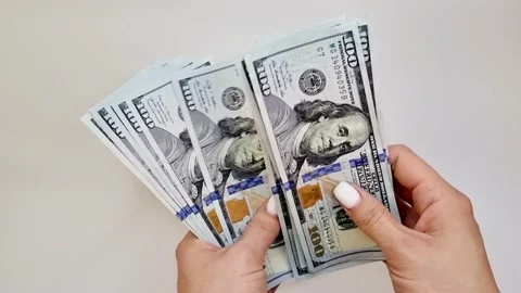 Recalculation of bundle of one hundred dollar bills Stock Footage 165847577