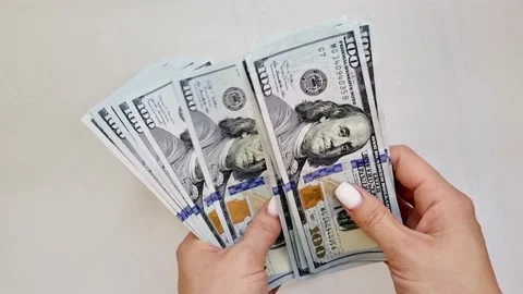 Recalculation of bundle of one hundred dollar bills Stock Footage 165847578