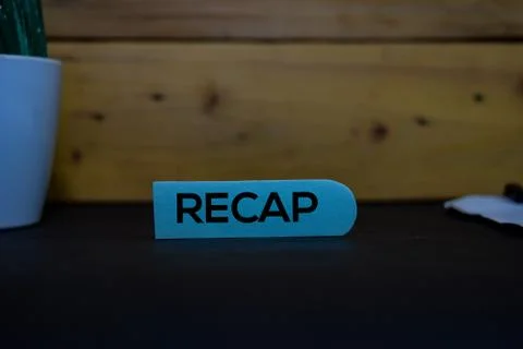 Recap write on a sticky note isolated on wooden background. Stock Photos