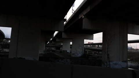 Receding perspective underneath an overhead overpass or flyover Stock Footage 153535074