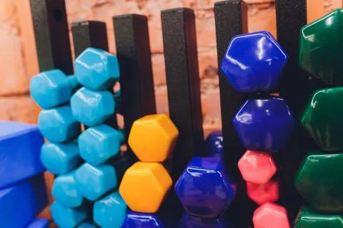 Receding row of weights lined up in a gym waiting for clients with focus to the Stock Photos