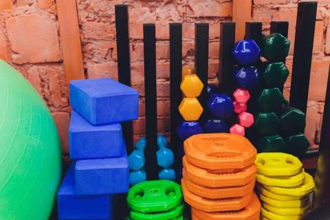 Receding row of weights lined up in a gym waiting for clients with focus to the Stock Photos
