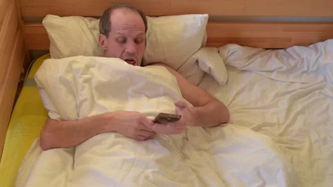 Receiving a call in bed Stock Footage 224861359