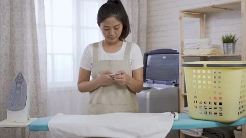 Receiving call from friend during housework Video stock 145179602